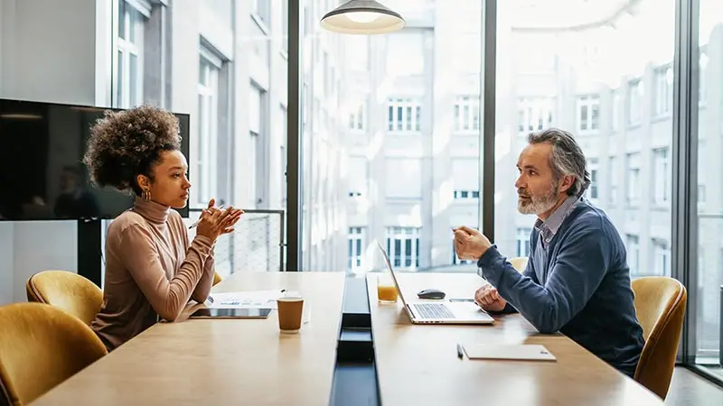 Man and woman discussing ETF trends at a conference table