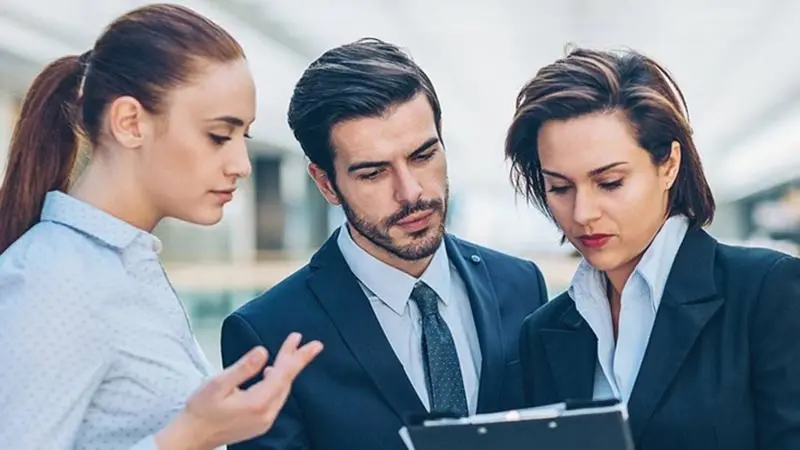 Three office colleagues looking at different ABL options
