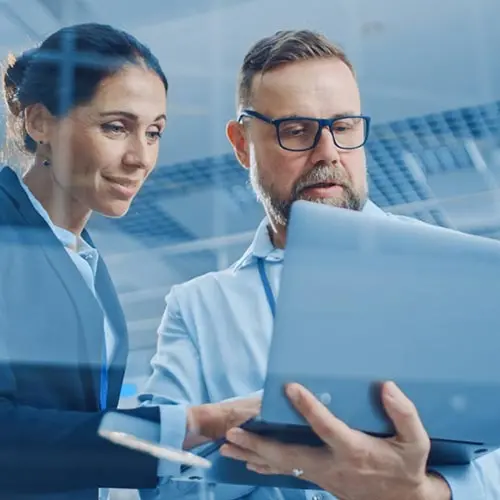 Man and woman looking at laptop in an office