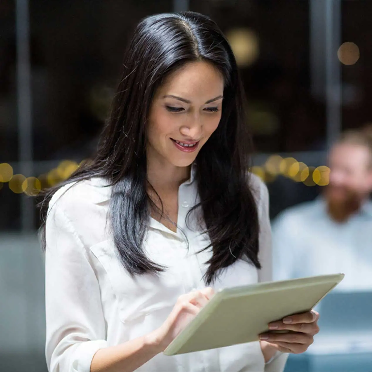 Woman using a tablet to monitor liquidity 