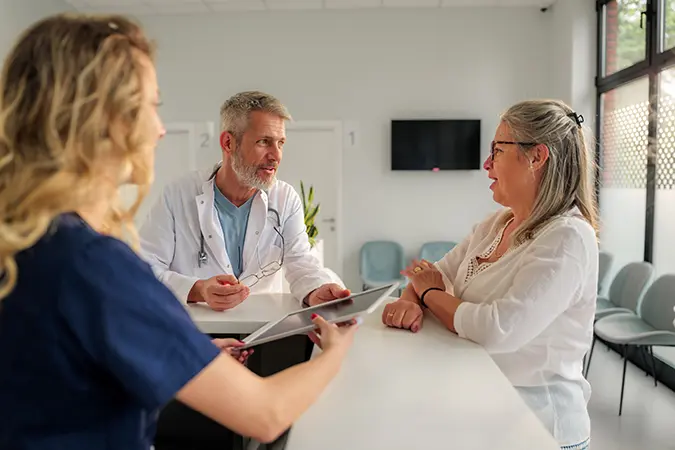 Doctor talking to a patient at front desk