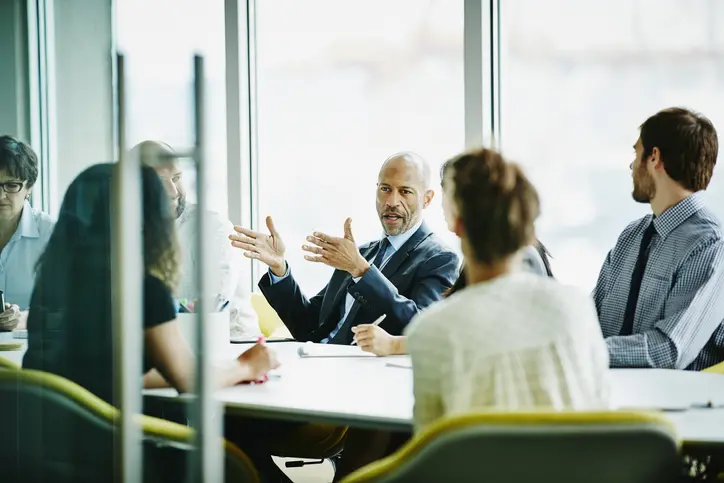 Office colleagues discussing what to look for in a successor trustee and their responsibilities
