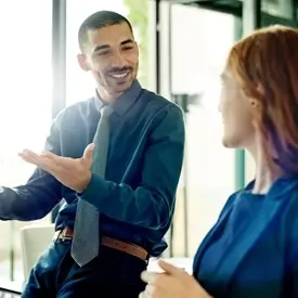 Two people talking in a conference room about fright solutions