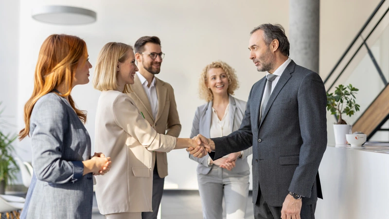 Five colleagues having a meeting discussing CLO market trends and top ai platforms for loan syndication and participation