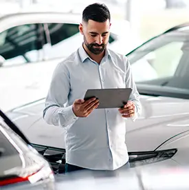 Man looking out driver's side window of vehicle. 