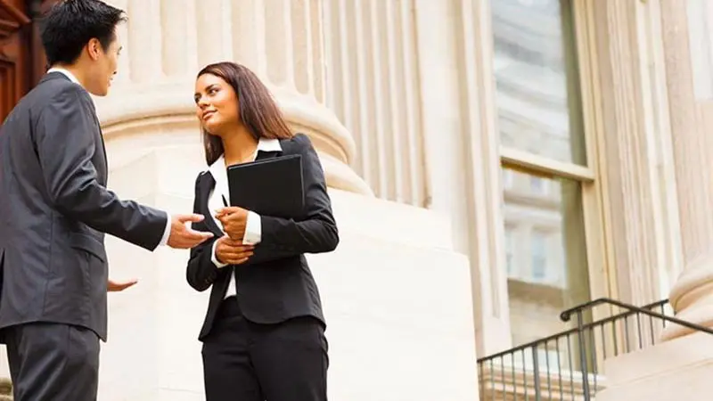 Two colleagues discussing how implementing service fees can improve payment acceptance processes for governments and institutions
