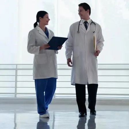 Two doctors walking down a hallway