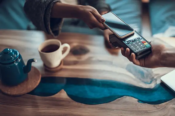 Using a smartphone to make a payment with a hand-held payment terminal.