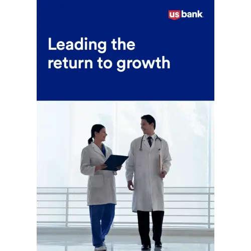 Two doctors walking down a hallway