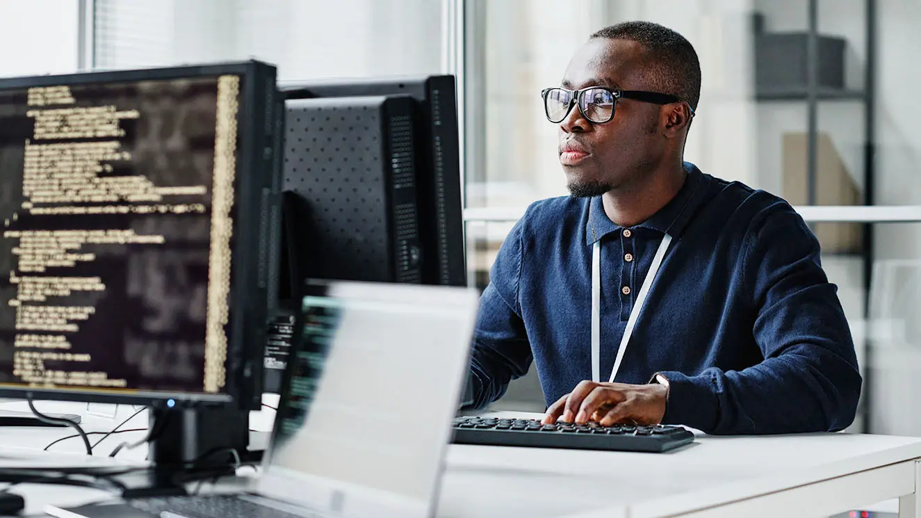 Business man reviewing data on a computer screen