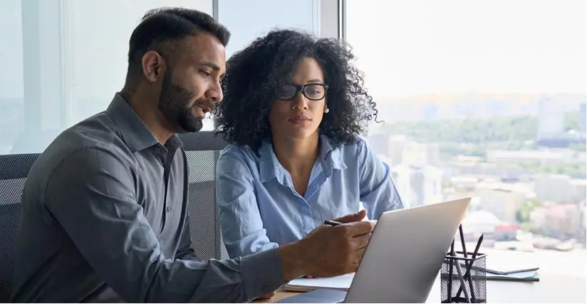 Man and woman in an office discussing digital onboarding.