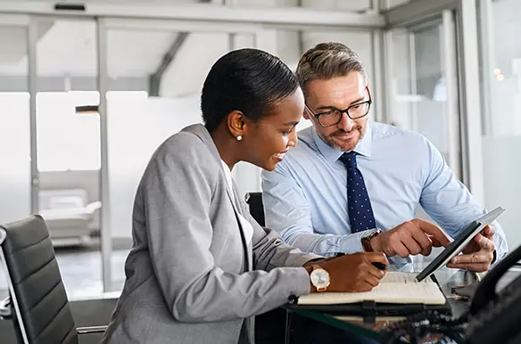 Colleagues discussing new B2B virtual card payment solutions for their business.