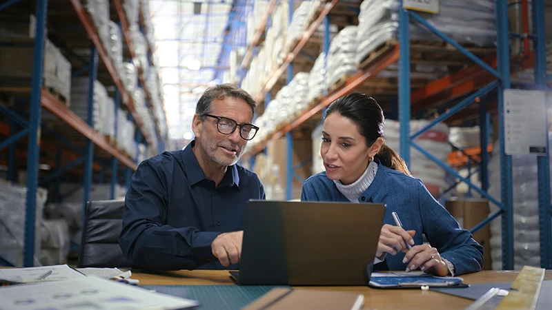 Office workers learning about supply chain financing strategies that enhance liquidity and operational continuity amid tariff challenges and global disruptions.