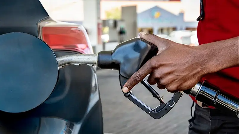 Man using a laptop in an airport to assess p-cards vs corporate cards
