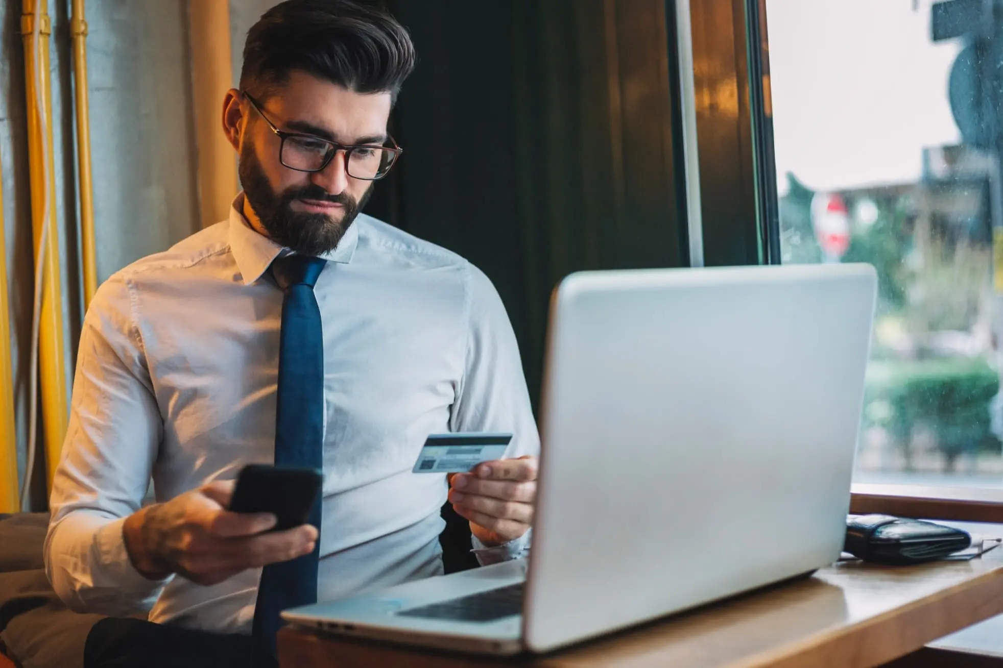 A person looking at the credit card and mobile