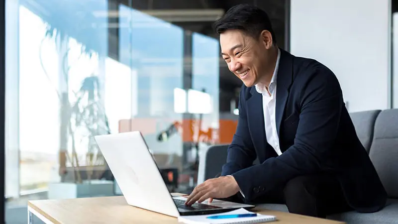 Smiling business man working on receivables.