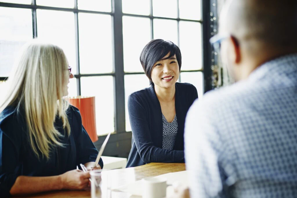 Two men shaking hands in office after discussing the unique challenges of the requirements of large PE firms.