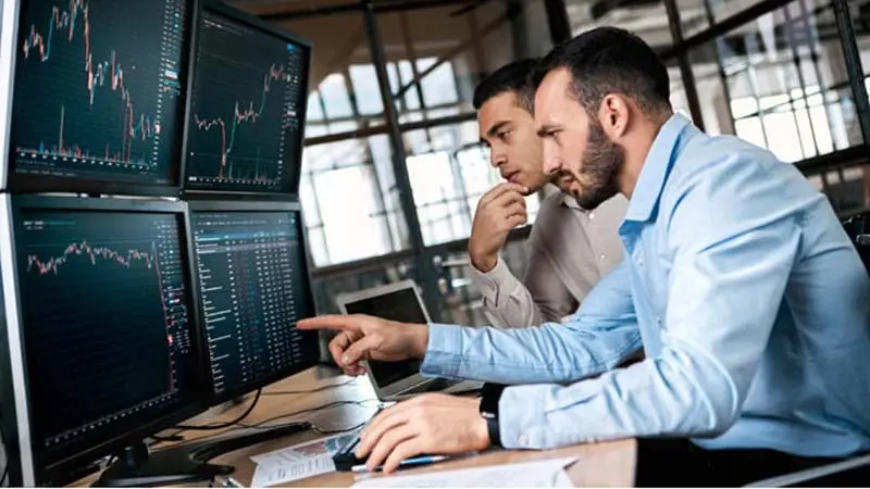 2 men using computer