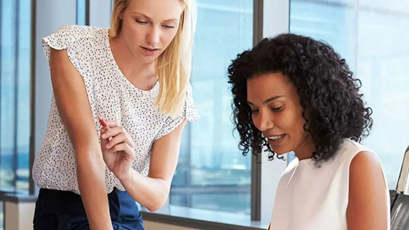 Two women looking at a screen