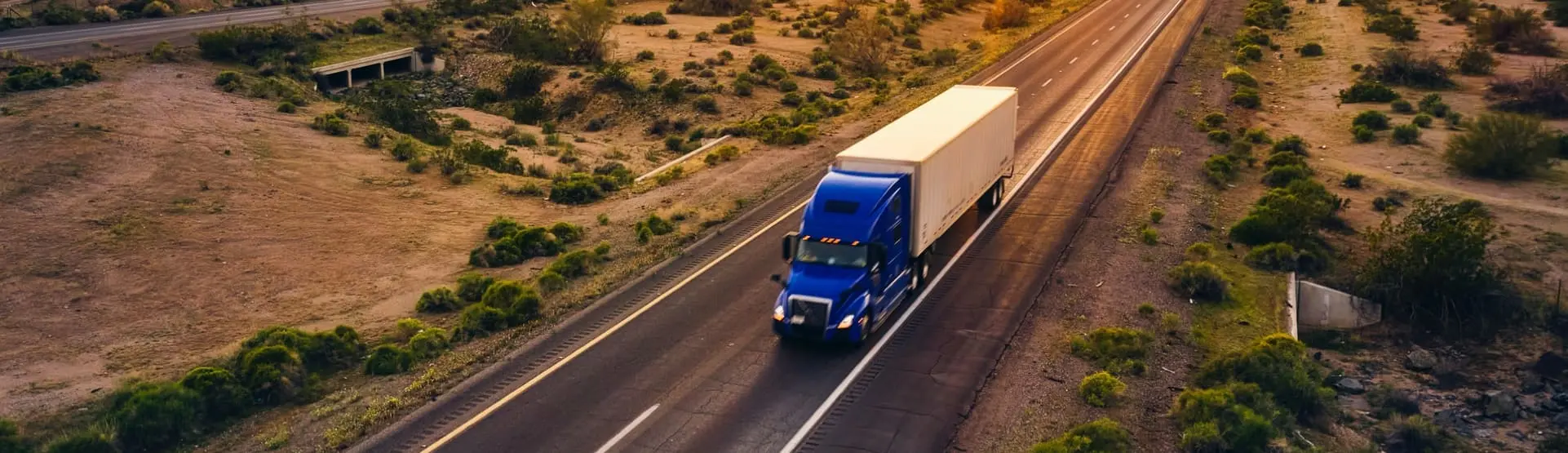 Semi-truck driving down a road