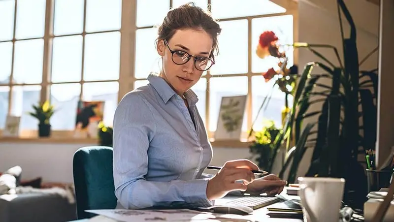 Woman working on a laptop computer.