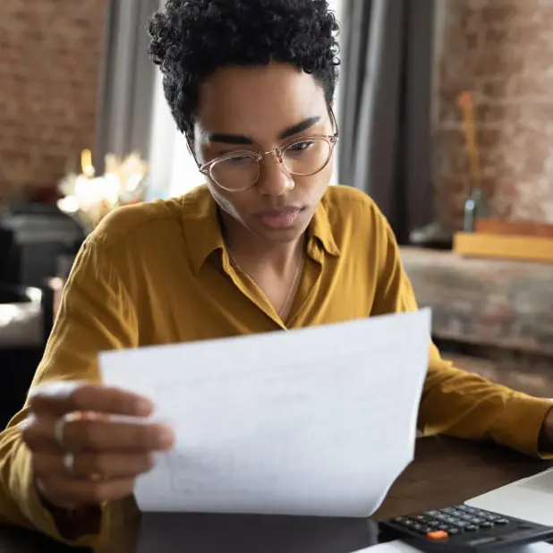 Women reading report with laptop