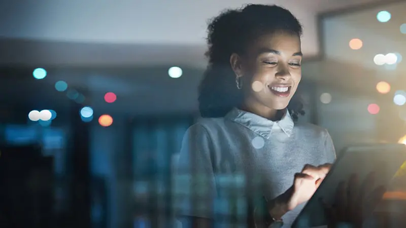 Young professional woman looking at private equity data on her tablet