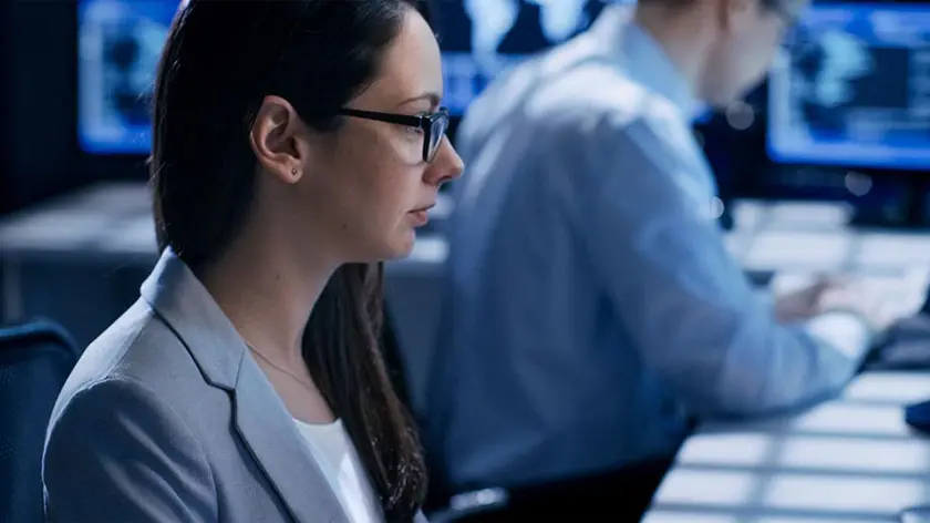 Woman investigating payment fraud at her computer