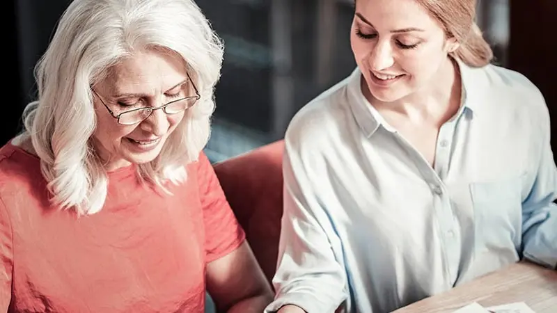 Mother and daughter reviewing business paperwork