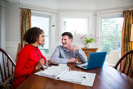 couple working on laptop at home