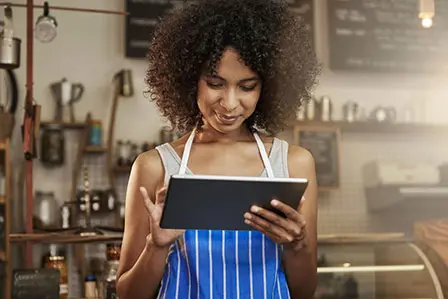 woman in shop using tablet