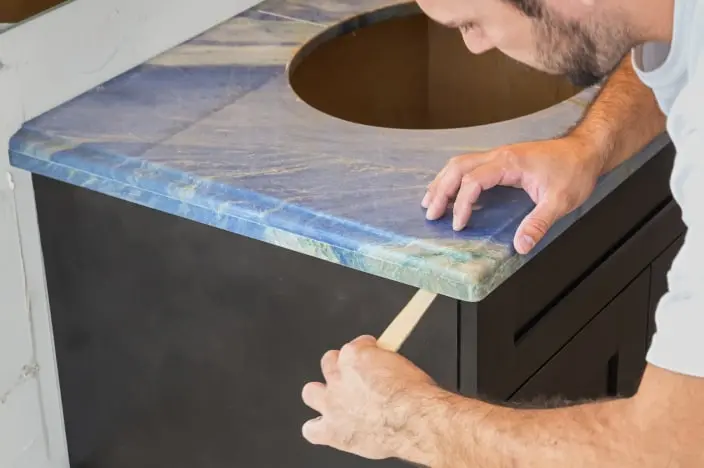 Man installing a new bathroom vanity countertop