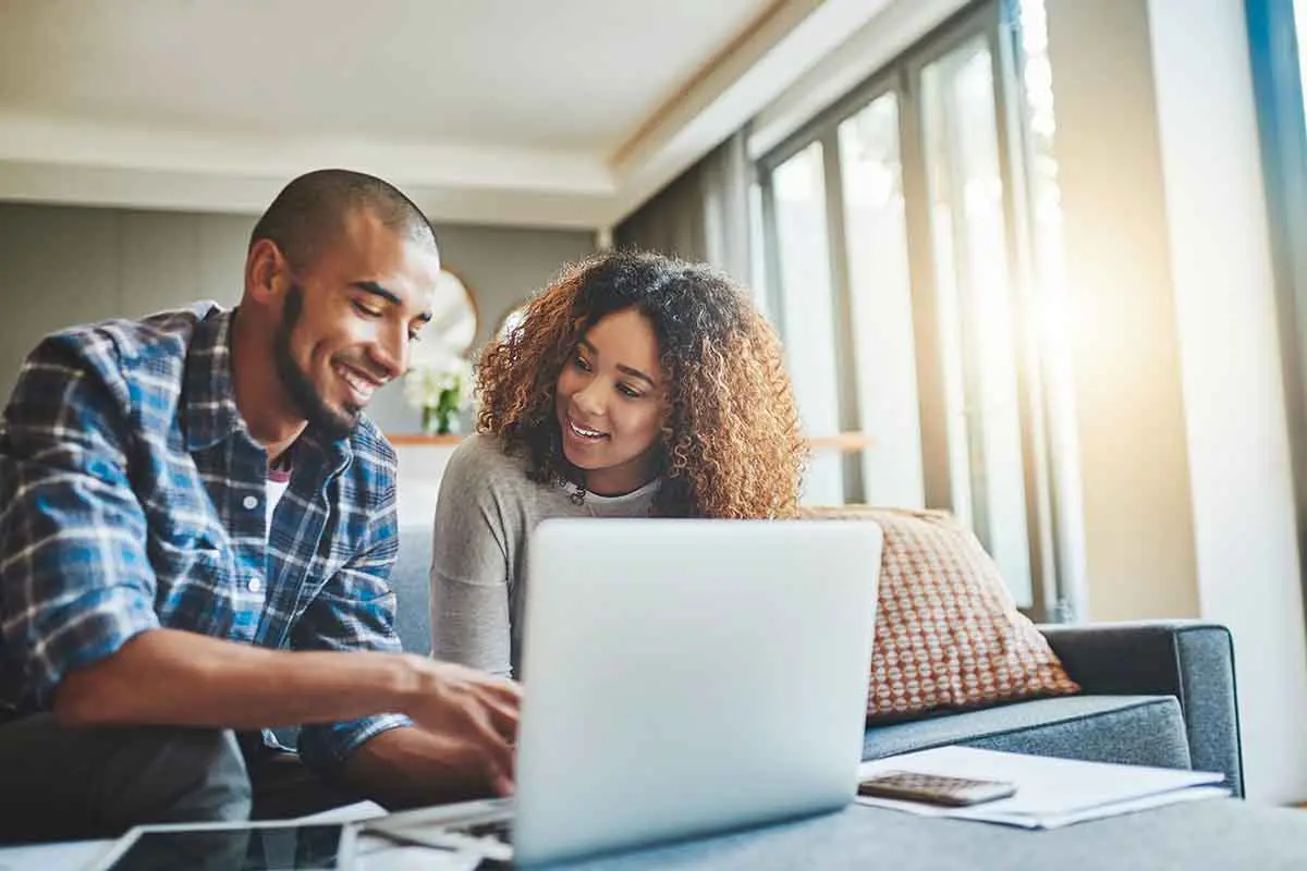 couple sitting on couch while discussing estate planning
