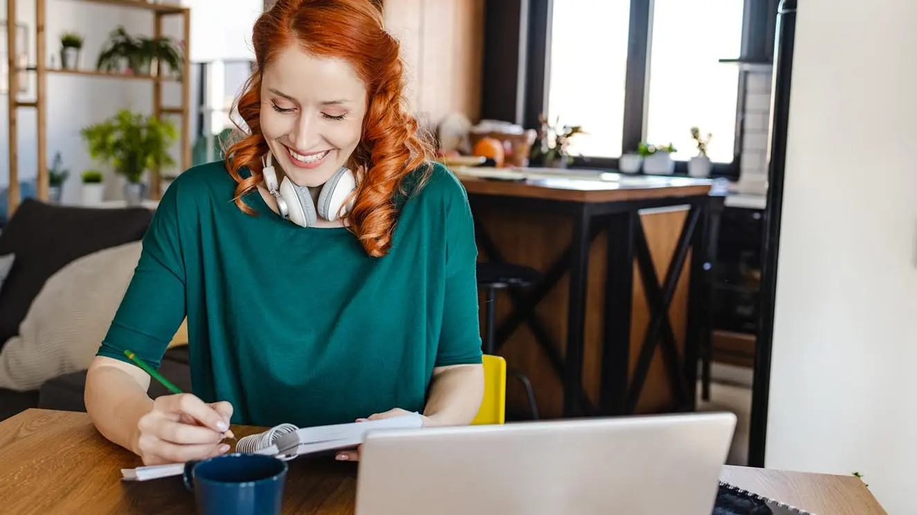 woman sitting at a desk working on a budget