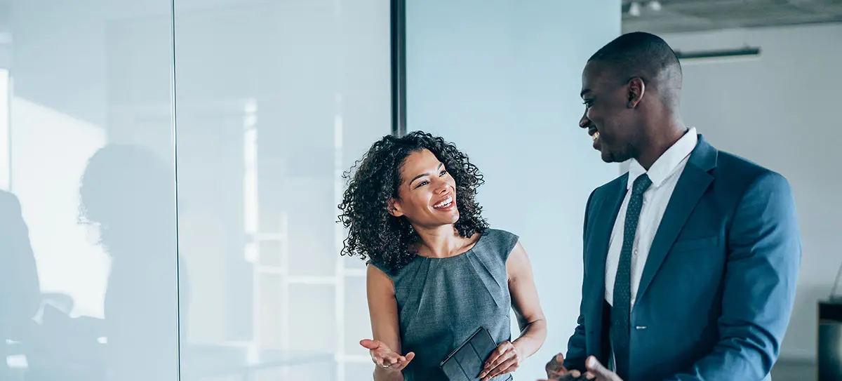 Man and woman speaking to each other in an office