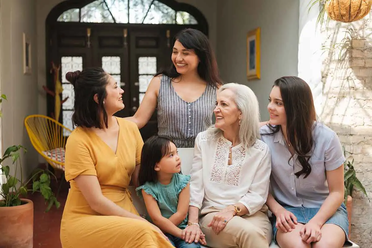 three generations of hispanic women gathered together in a group