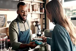 Customer making transaction at a coffee shop