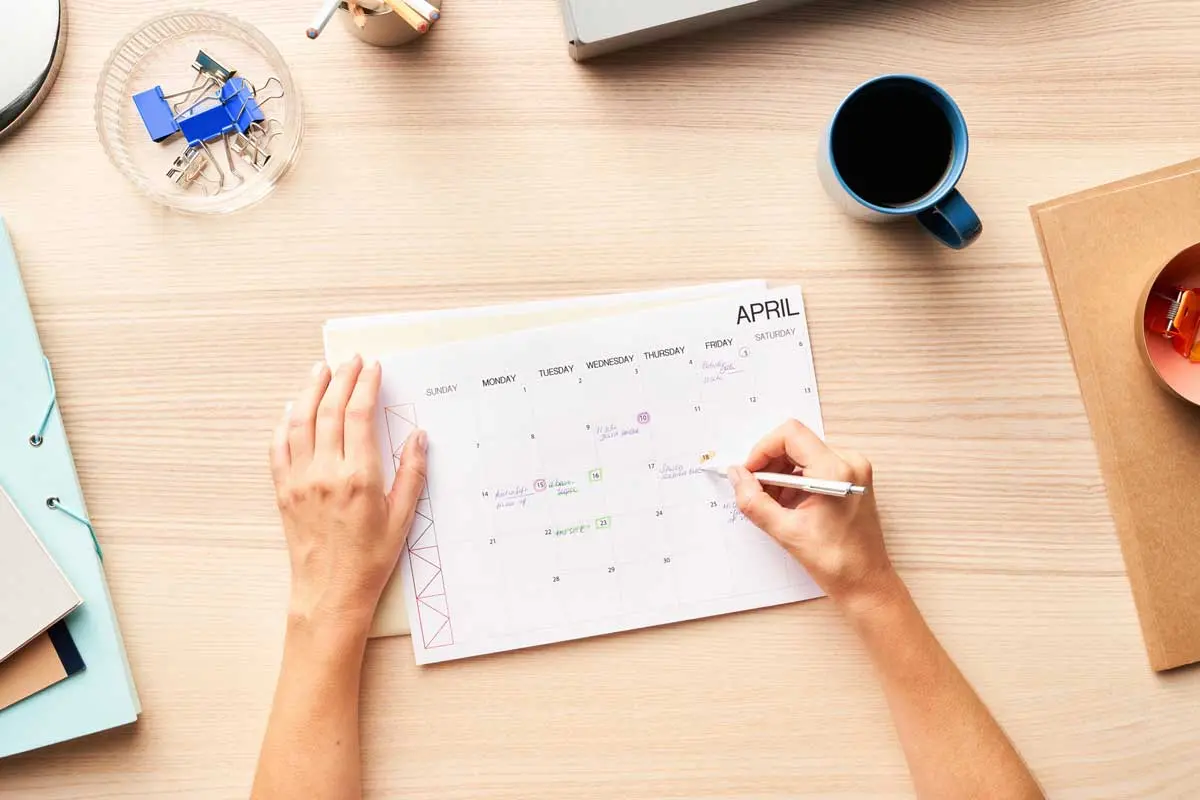 a personal calendar on a desk showing the month of April