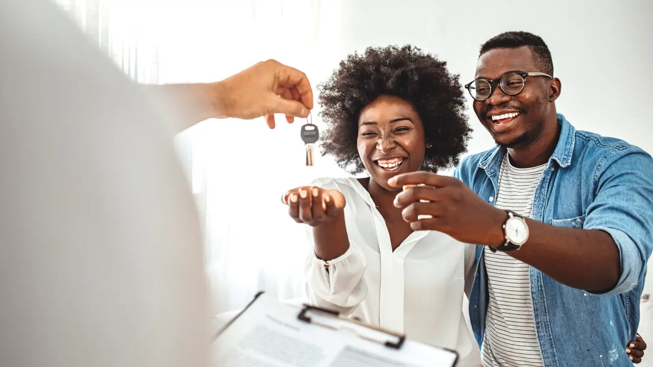 a couple being handed the keys to their new home