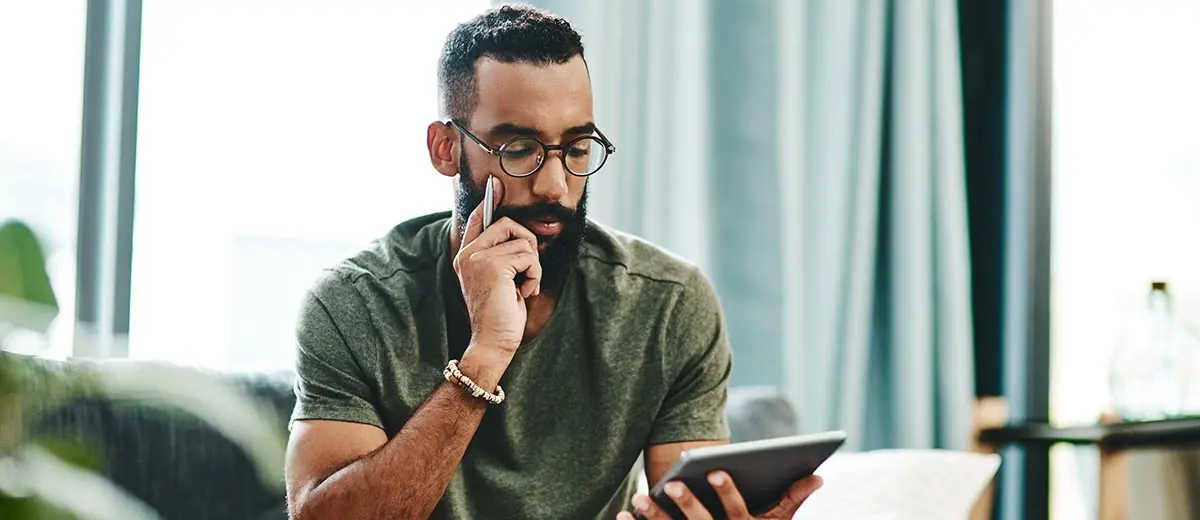 a man in a green shirt looking at a tablet