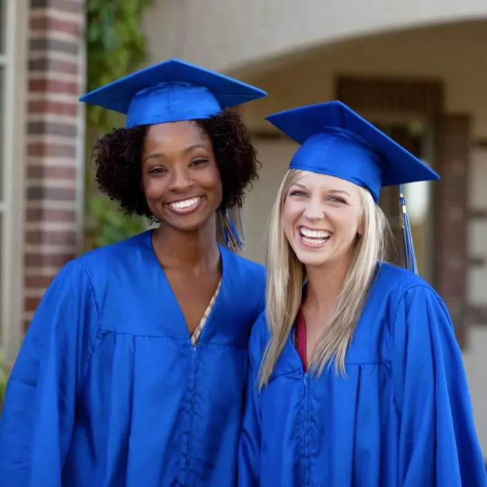 Two female students celebrating their college graduation