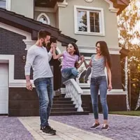 a man and woman holding hands with a young girl