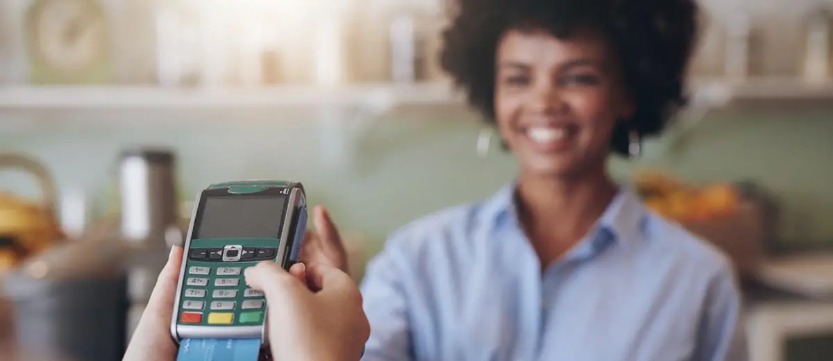 a woman looking at a credit card machine
