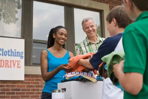 woman collecting donations at a clothing drive