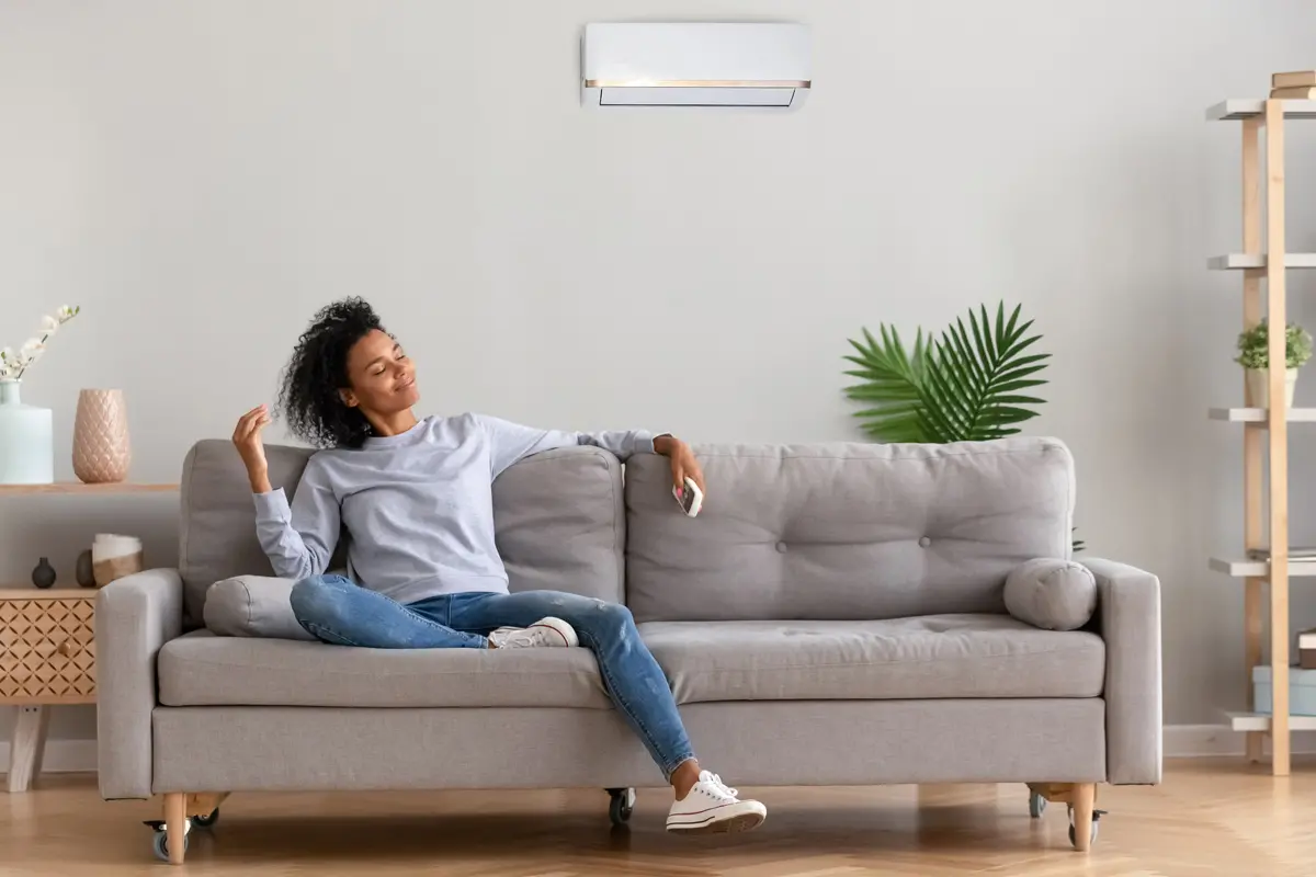 woman relaxing on a grey couch