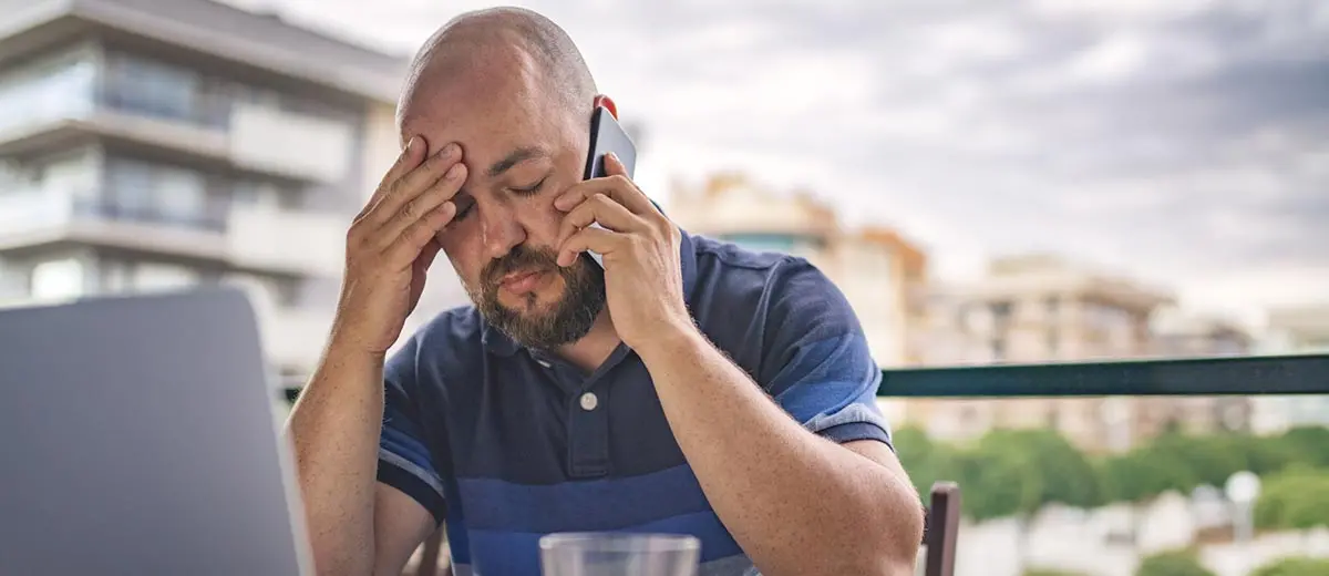 a man on the phone looking frustrated