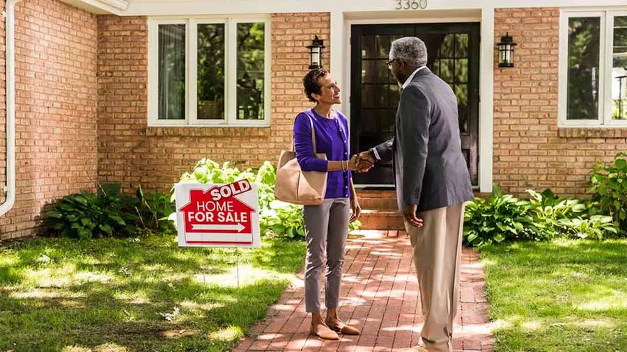 A man and woman in front of purchasing their home for the first-time