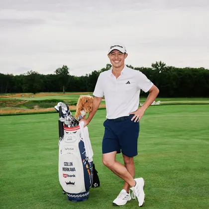 Professional golfer Colin Morikawa poses on a golf course with his clubs