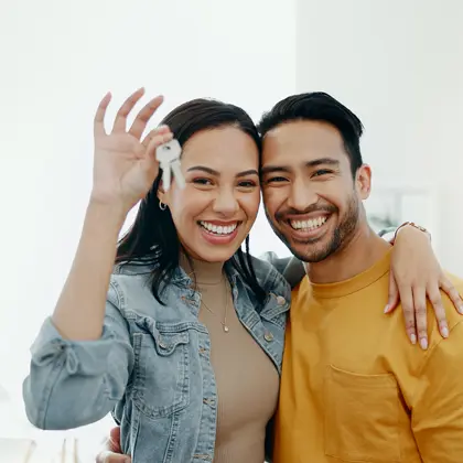 Couple holding keys to new house