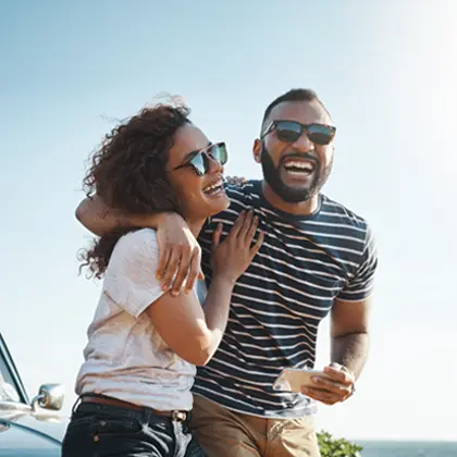 Man and woman with arms around each other, smiling